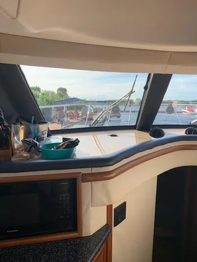  Yacht Photos Pics Interior view of 1999 Carver 450 Voyager yacht with kitchen and scenic window.