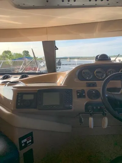  Yacht Photos Pics 1999 Carver 450 Voyager helm with navigation instruments and scenic water view.