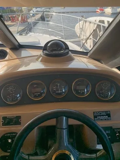  Yacht Photos Pics 1999 Carver 450 Voyager helm with gauges and compass, docked at marina.