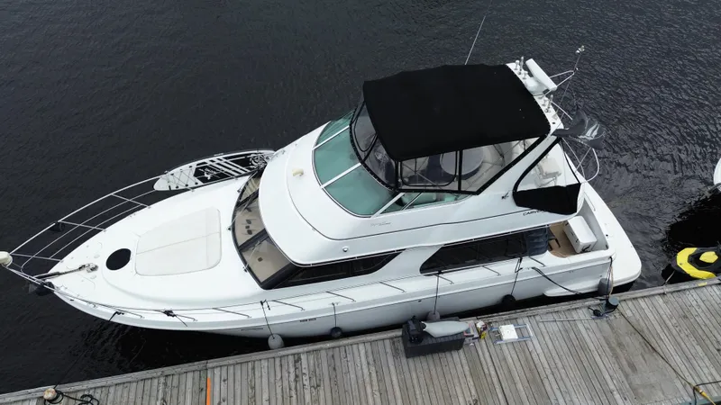  Yacht Photos Pics 1999 Carver 450 Voyager yacht docked at marina, aerial view.
