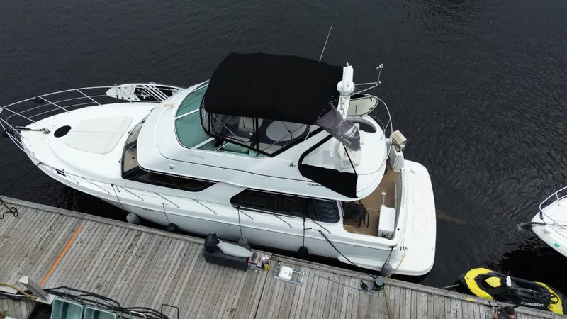  Yacht Photos Pics 1999 Carver 450 Voyager yacht docked at marina, aerial view.