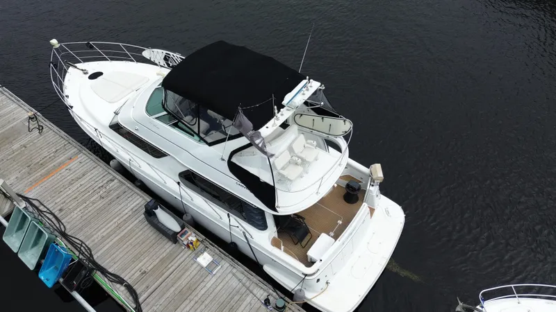  Yacht Photos Pics 1999 Carver 450 Voyager yacht docked at a marina, aerial view.