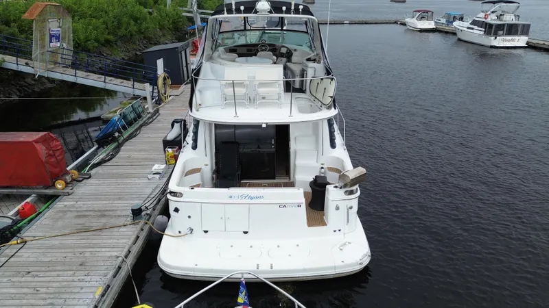  Yacht Photos Pics 1999 Carver 450 Voyager yacht docked at marina, rear view.