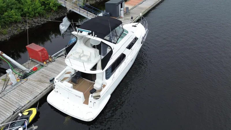  Yacht Photos Pics 1999 Carver 450 Voyager yacht docked at marina, aerial view.