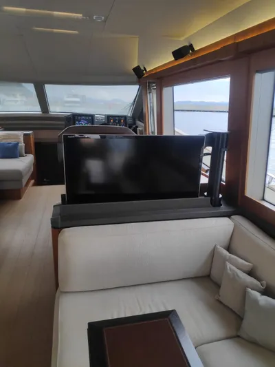  Yacht Photos Pics Interior of 2013 Monte Carlo Yachts MCY 65, featuring a modern lounge with a retractable TV.