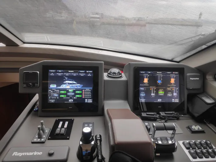  Yacht Photos Pics Cockpit of 2013 Monte Carlo Yachts MCY 65 with Raymarine navigation displays.