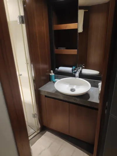  Yacht Photos Pics Luxurious bathroom in 2013 Monte Carlo Yachts MCY 65 with modern fixtures and wood accents.