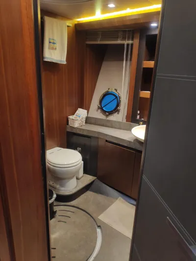  Yacht Photos Pics Luxurious bathroom in 2013 Monte Carlo Yachts MCY 65 with wood accents and modern fixtures.
