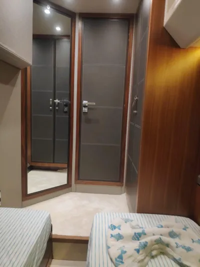  Yacht Photos Pics Interior of 2013 Monte Carlo Yachts MCY 65 with twin beds and mirrored closet.