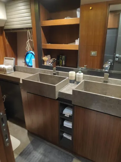  Yacht Photos Pics Luxurious bathroom in 2013 Monte Carlo Yachts MCY 65 with dual sinks and wooden cabinetry.