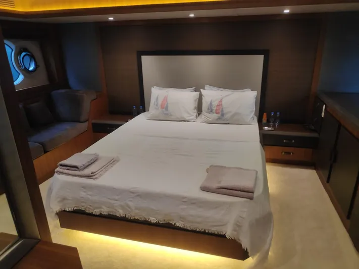  Yacht Photos Pics Luxurious bedroom in 2013 Monte Carlo Yachts MCY 65, featuring elegant bedding and ambient lighting.