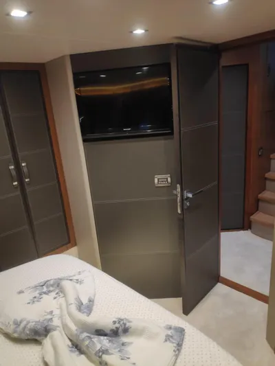  Yacht Photos Pics Luxurious interior of 2013 Monte Carlo Yachts MCY 65 with modern design and cozy bedding.