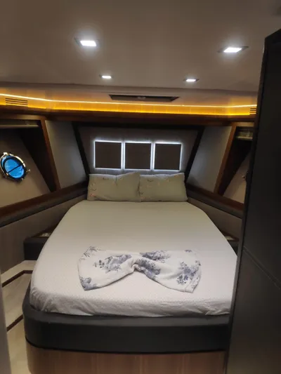 Yacht Photos Pics Luxurious bedroom interior of 2013 Monte Carlo Yachts MCY 65 with elegant lighting and decor.