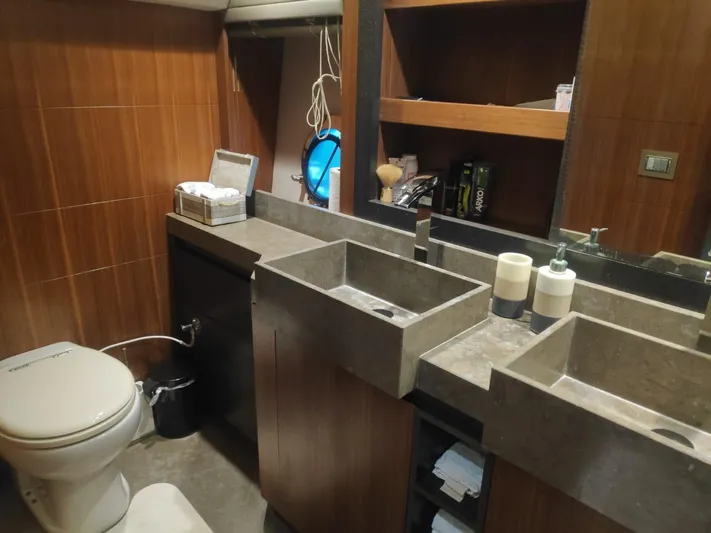  Yacht Photos Pics Luxurious bathroom in 2013 Monte Carlo Yachts MCY 65 with modern fixtures and wooden accents.