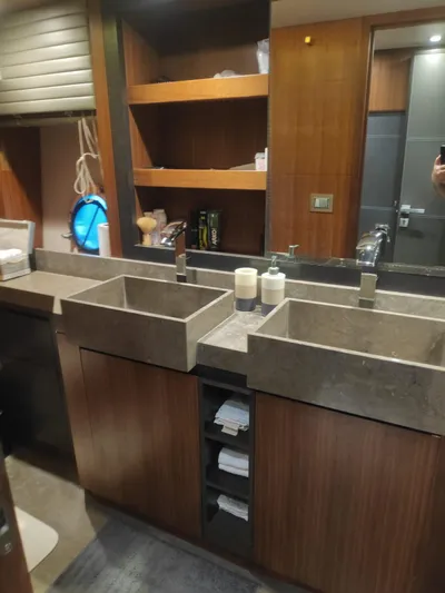  Yacht Photos Pics Luxurious bathroom in 2013 Monte Carlo Yachts MCY 65 with dual sinks and wooden cabinetry.