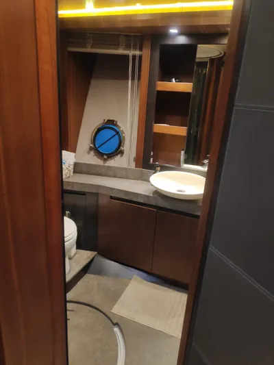  Yacht Photos Pics Luxurious bathroom in 2013 Monte Carlo Yachts MCY 65 with modern fixtures and porthole.