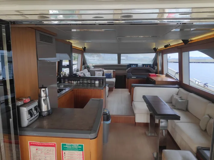  Yacht Photos Pics Luxurious interior of 2013 Monte Carlo Yachts MCY 65 with modern kitchen and seating area.