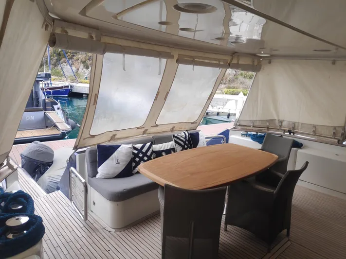  Yacht Photos Pics Luxurious 2013 Monte Carlo Yachts MCY 65 deck with elegant seating and dining area.