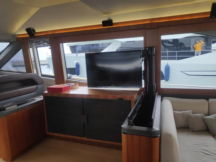  Yacht Photos Pics Interior of 2013 Monte Carlo Yachts MCY 65 with TV and sofa, showcasing luxury design.