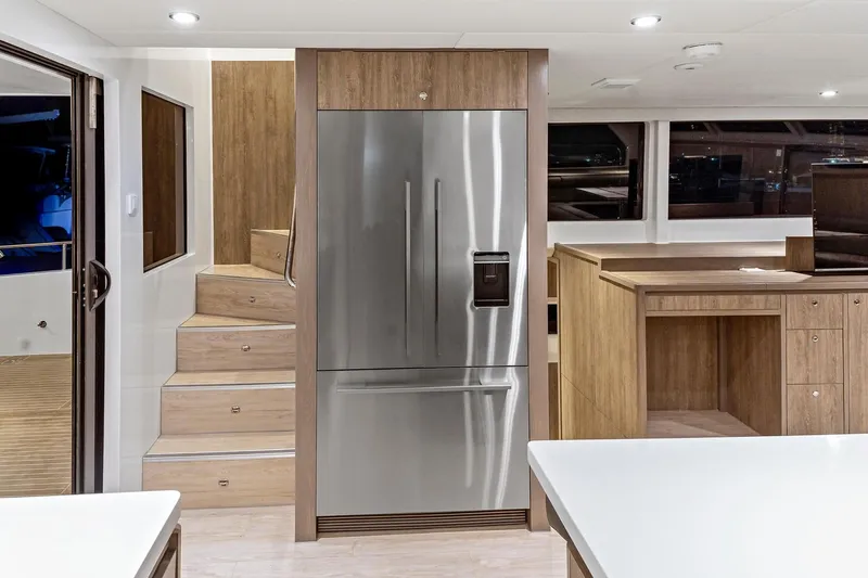 Innforapenny III Yacht Photos Pics Interior of 2020 PowerPlay Catamarans Longreach 1900 Expedition with modern kitchen and stainless steel fridge.