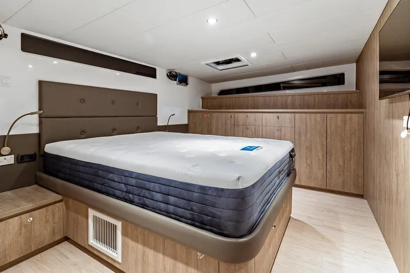 Innforapenny III Yacht Photos Pics Luxurious bedroom interior of 2020 PowerPlay Catamarans Longreach 1900 Expedition with modern design.