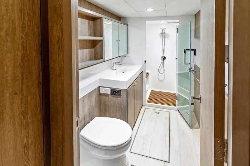 Innforapenny III Yacht Photos Pics Luxurious bathroom in 2020 PowerPlay Catamarans Longreach 1900 Expedition, featuring modern fixtures and wood accents.