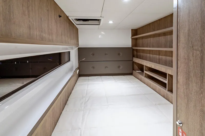 Innforapenny III Yacht Photos Pics Interior of 2020 PowerPlay Catamarans Longreach 1900 Expedition, featuring modern wood finishes and shelving.