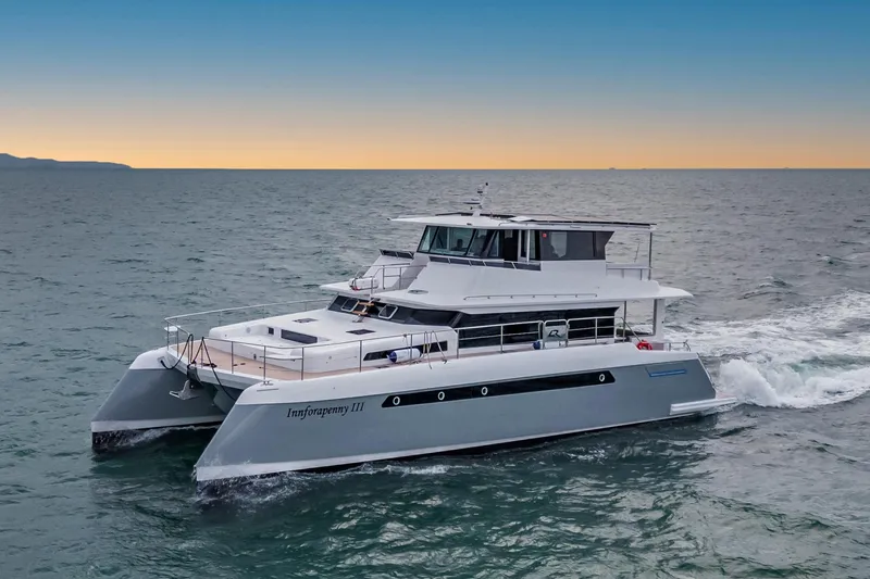 Innforapenny III Yacht Photos Pics 2020 PowerPlay Catamarans Longreach 1900 Expedition cruising at sea during sunset.