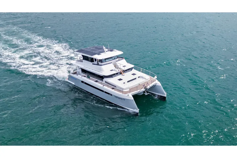 Innforapenny III Yacht Photos Pics PowerPlay Catamarans Longreach 1900 Expedition 2020 cruising on open water.