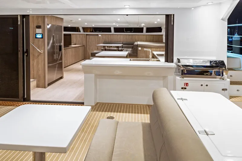 Innforapenny III Yacht Photos Pics Luxurious interior of 2020 PowerPlay Catamarans Longreach 1900 Expedition, featuring modern kitchen and seating.