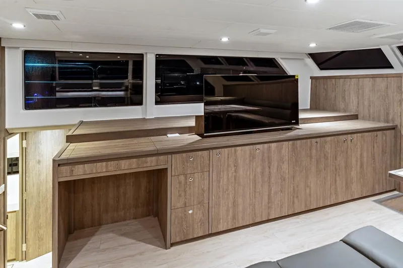 Innforapenny III Yacht Photos Pics Luxurious interior of 2020 PowerPlay Catamarans Longreach 1900 Expedition with modern wood cabinetry.