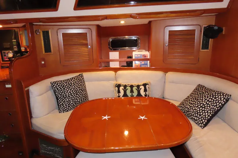 Sea Pearl Yacht Photos Pics Luxurious 1998 Hylas 54' yacht interior with cozy seating and elegant wooden table.