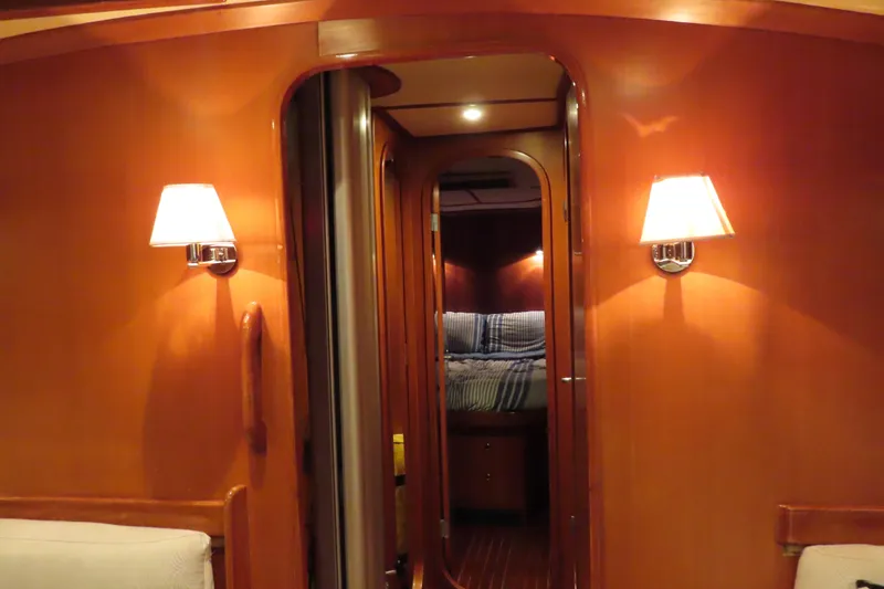 Sea Pearl Yacht Photos Pics Interior of 1998 Hylas 54' yacht with warm wood paneling and cozy lighting.