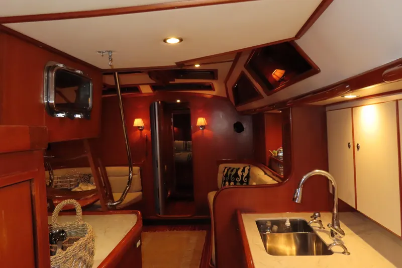 Sea Pearl Yacht Photos Pics Luxurious interior of a 1998 Hylas 54' yacht with elegant wood finishes.