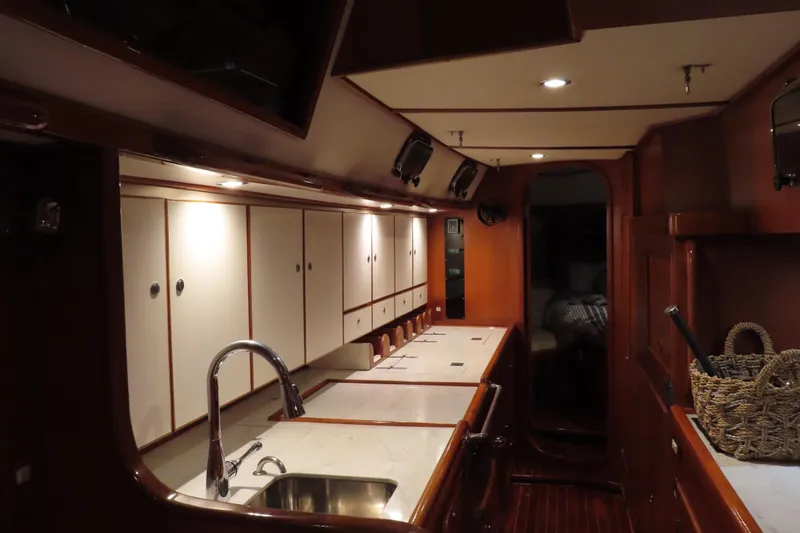 Sea Pearl Yacht Photos Pics Luxurious interior of a 1998 Hylas 54' yacht with elegant wood cabinetry and modern fixtures.