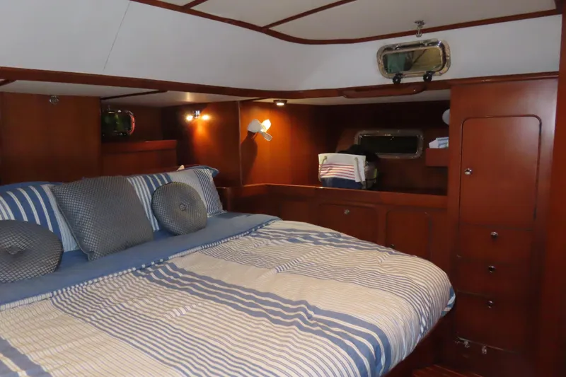 Sea Pearl Yacht Photos Pics Luxurious cabin interior of a 1998 Hylas 54' yacht with striped bedding.