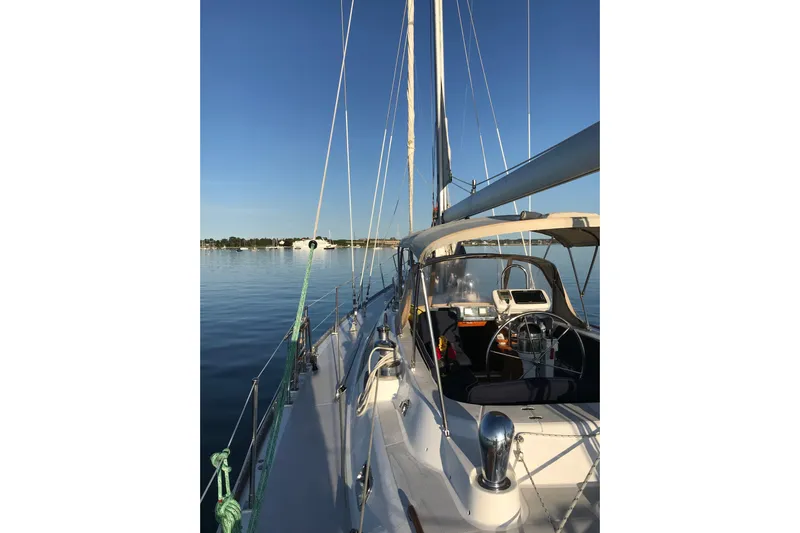 Sea Pearl Yacht Photos Pics Sailing yacht Hylas 54', 1998 model, on calm waters under clear blue sky.