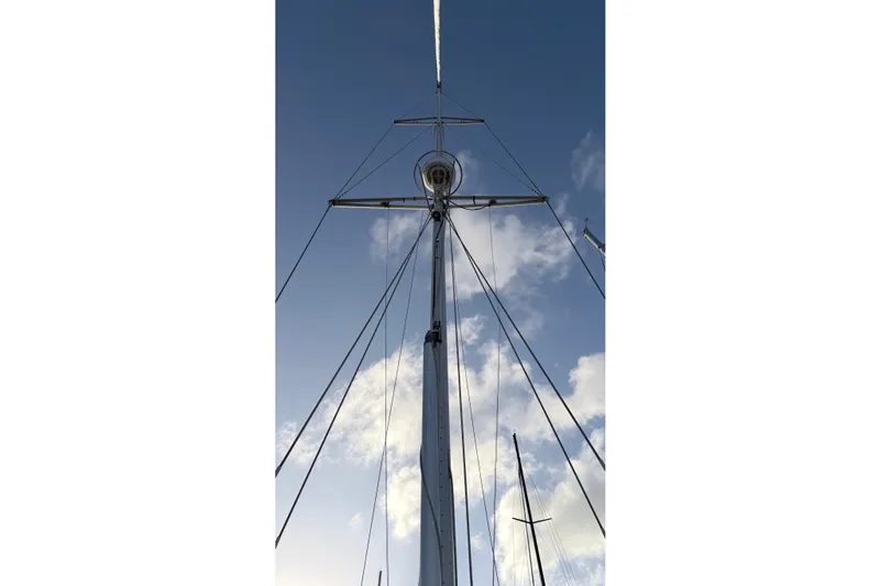 Sea Pearl Yacht Photos Pics Mast of 1998 Hylas 54' sailboat against a blue sky with clouds.