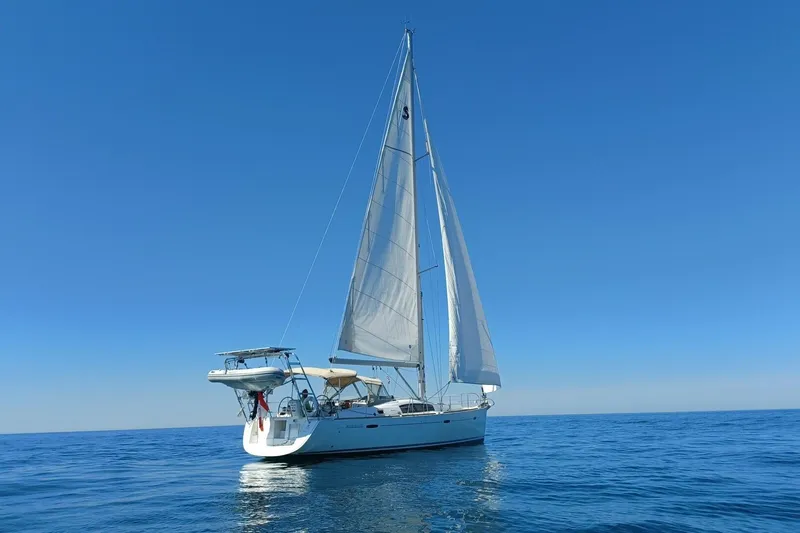 J'ouvert Yacht Photos Pics 2009 Beneteau 43 sailboat on calm blue sea under clear sky.