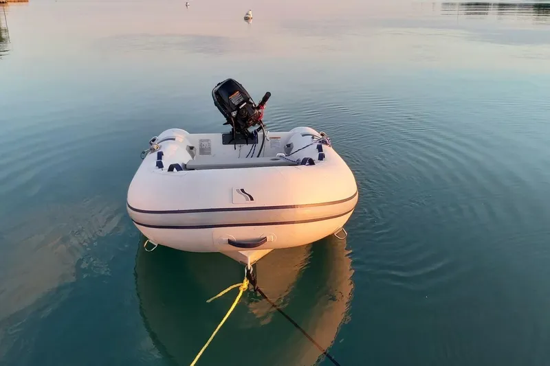 J'ouvert Yacht Photos Pics Inflatable dinghy on calm water, associated with 2009 Beneteau 43 yacht.