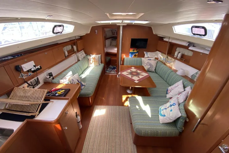 J'ouvert Yacht Photos Pics Interior of 2009 Beneteau 43 yacht with cozy seating and wooden finishes.