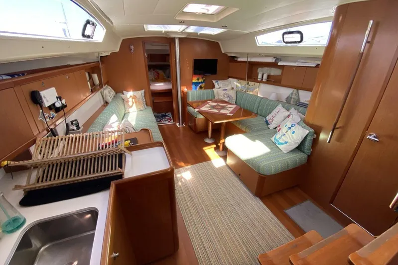 J'ouvert Yacht Photos Pics Interior of a 2009 Beneteau 43 yacht with cozy seating and wooden finishes.