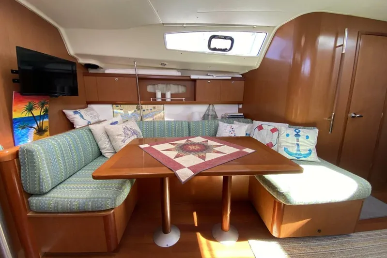 J'ouvert Yacht Photos Pics Interior of 2009 Beneteau 43 yacht with cozy seating and nautical decor.