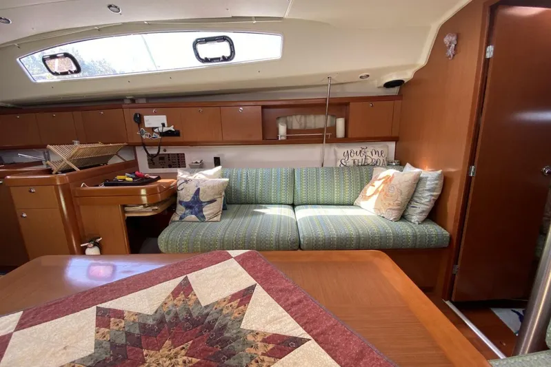 J'ouvert Yacht Photos Pics Interior of 2009 Beneteau 43 yacht with cozy seating and nautical decor.