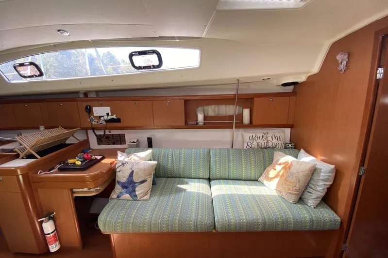 J'ouvert Yacht Photos Pics Interior of 2009 Beneteau 43 yacht with cozy seating and decorative pillows.