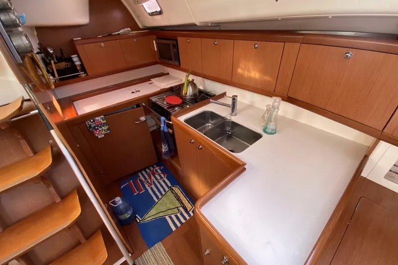 J'ouvert Yacht Photos Pics Galley kitchen in 2009 Beneteau 43 sailboat with wood cabinetry and dual sink.