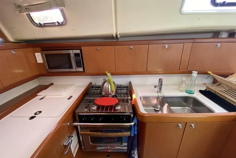 J'ouvert Yacht Photos Pics Galley kitchen in 2009 Beneteau 43 sailboat with stove, sink, and microwave.