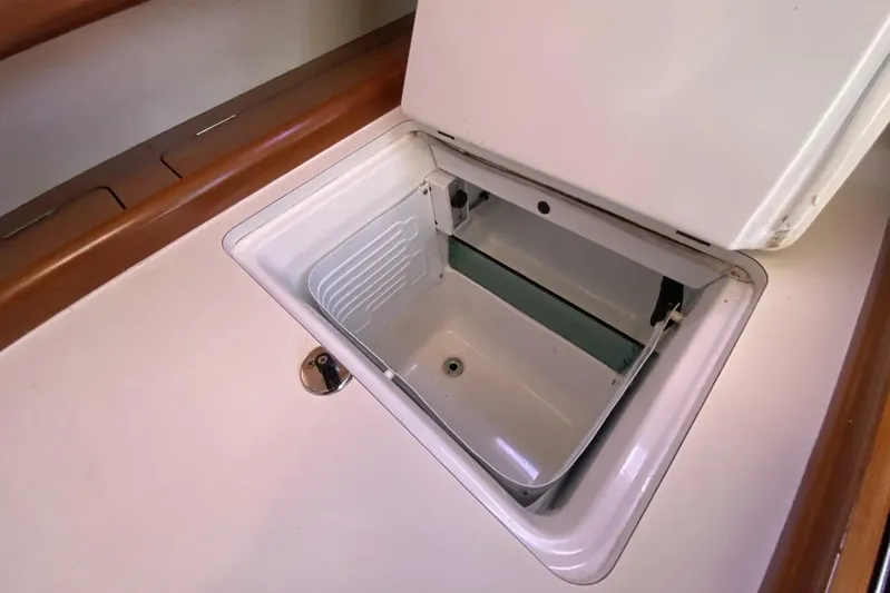 J'ouvert Yacht Photos Pics Open storage compartment on 2009 Beneteau 43 yacht, featuring a sleek white interior.