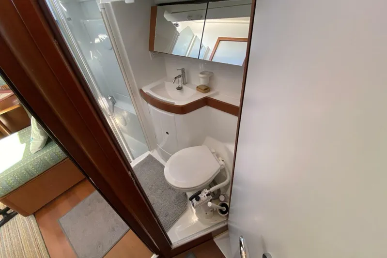 J'ouvert Yacht Photos Pics Compact bathroom in 2009 Beneteau 43 yacht with sink, toilet, and shower.