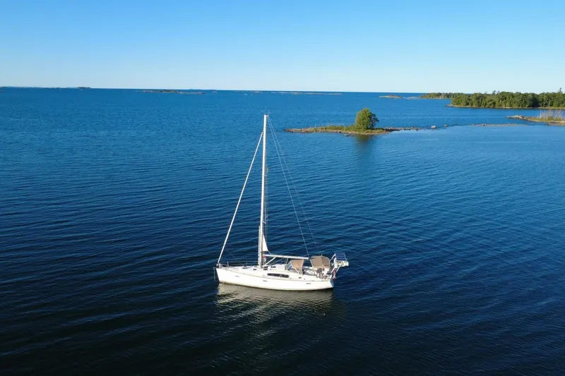 J'ouvert Yacht Photos Pics Sailboat Beneteau 43 (2009) on serene blue water near small islands.